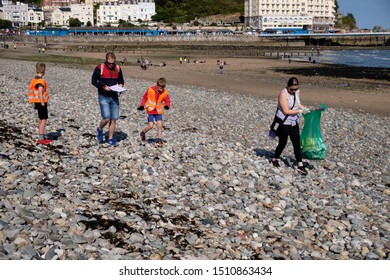 Llandudno,  UK. 21 September 2019.  People Of All Ages Gather For The Annual Beach Cleaning And Data Collecting On A Beautiful Sunny Autumn Day.  Volunteers  In The Event Removed Rubbish From Beach
