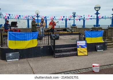 Llandudno, UK: Apr 10, 2022: The bandstand on Llandudno Promenade is pictured hosting Jabberwocky, a local band. They are raising funds to support the British Red Cross to help Ukraine