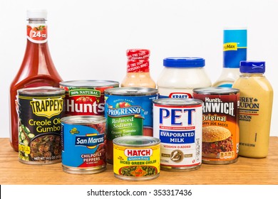 LLANO, TX-DEC 19, 2015: Canned And Bottled Groceries On Food Pantry Shelf With White Background And Copy Space.  Various Trademark Brand Names.