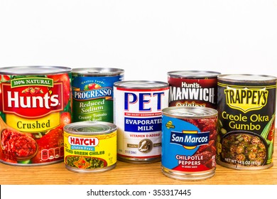 LLANO, TX-DEC 19, 2015: Donated Canned Goods On Shelf At Food Pantry For The Needy.  White Background With  Copy Space.