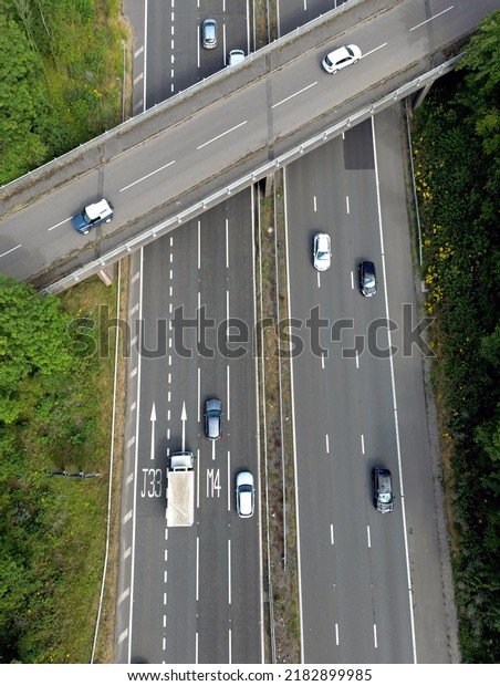 Llantrisant, Wales - July 2022: Aerial view of\
vehicles over road markings informing drivers of lanes to take\
approaching a\
junction