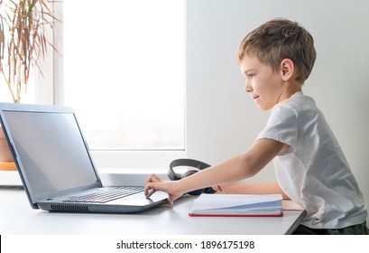 Llittle boy performs an online lesson. Online education. Preschooler boy using laptop. - Powered by Shutterstock