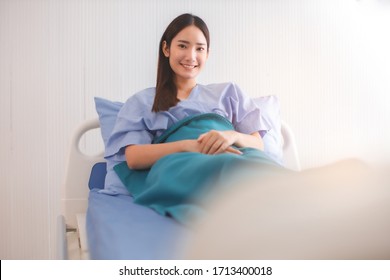 llness asia patient women and hospital concept - illness asian patient women on bed seeing windows in room alone of hospital - Powered by Shutterstock