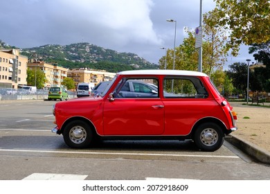 Lloret De Mar, Catalonia, Spain - 11.11.2021: Bright Red Mini 850 Model Old Retro Car In Perfect Condition Parked On The City Street, Side View