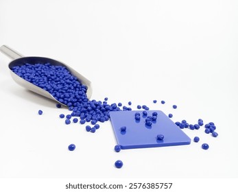 LLPE plastic masterbatch, blue plastic masterbatch granules with chips, polymer resin with scope carrying pigment poured on white background, suitable for industrial plastic product catalog design