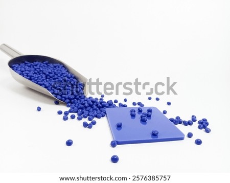 LLPE plastic masterbatch, blue plastic masterbatch granules with chips, polymer resin with scope carrying pigment poured on white background, suitable for industrial plastic product catalog design