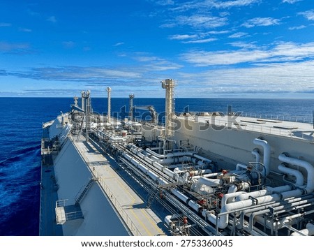 LNG carrier ship deck with complex pipeline system sailing in open ocean, global gas energy transport and maritime logistics. Membrane type tank NO96 