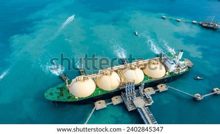 LNG (Liquefied natural gas) tanker anchored in Gas terminal gas tanks for storage. Oil Crude Gas Tanker Ship. LPG at Tanker Bay Petroleum Chemical or Methane freighter export import transportation	

