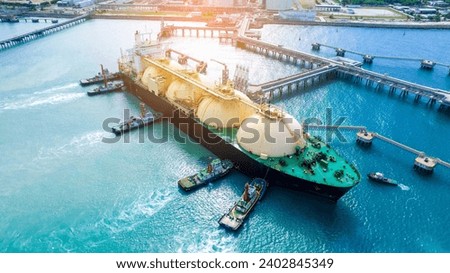 LNG (Liquefied natural gas) tanker anchored in Gas terminal gas tanks for storage. Oil Crude Gas Tanker Ship. LPG at Tanker Bay Petroleum Chemical or Methane freighter export import transportation	

