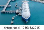 LNG (Liquified Natural Gas) tanker anchored in Gas terminal gas tanks for storage. Oil Crude Gas Tanker Ship. LPG at Tanker Bay Petroleum Chemical or Methane freighter export import transportation