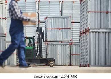 Load transportation machine with large container and worker carrying box