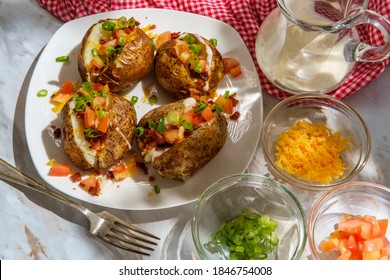 Loaded Baked Potato With Cheddar Cheese Crumbled Bacon Bits Scallions Diced Tomatoes And Ranch Dressing