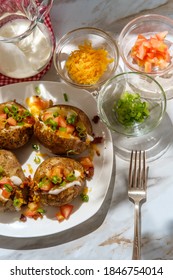 Loaded Baked Potato With Cheddar Cheese Crumbled Bacon Bits Scallions Diced Tomatoes And Ranch Dressing