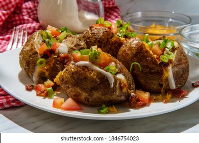 Loaded Baked Potato With Cheddar Cheese Crumbled Bacon Bits Scallions Diced Tomatoes And Ranch Dressing