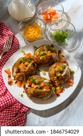 Loaded Baked Potato With Cheddar Cheese Crumbled Bacon Bits Scallions Diced Tomatoes And Ranch Dressing