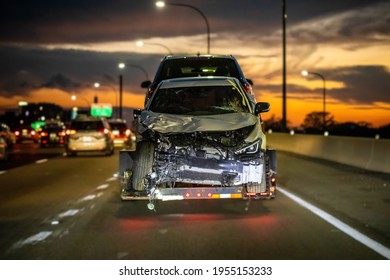 Loaded Broken Wrecked Car On A Tow Truck After Crash At Night