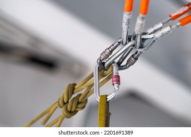 Loaded climbing station at an industrial facility. Climbing rope is bent into steel slings with carabiners. Industrial alpinism. - Powered by Shutterstock