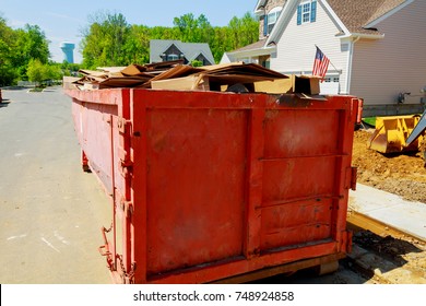 Loaded Dumpster Near A Construction, Home Renovation