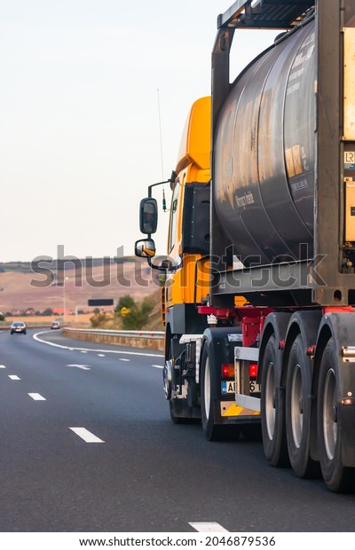 Loaded\
European truck in motion on asphalt road, transportation and\
delivery concept. Bucharest, Romania,\
2020