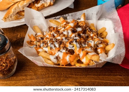 Loaded French fries with bacon, ranch and buffalo sauce