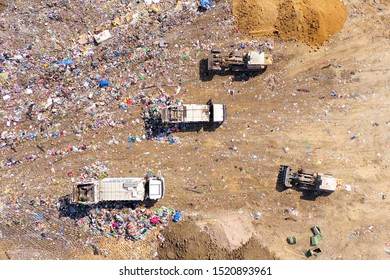 Loaded Garbage Trucks At A Municipal Landfill, Top Down Aerial Image.