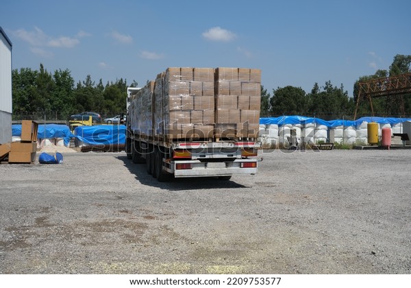 loaded truck, box loaded trailer on open custom\
transport area 