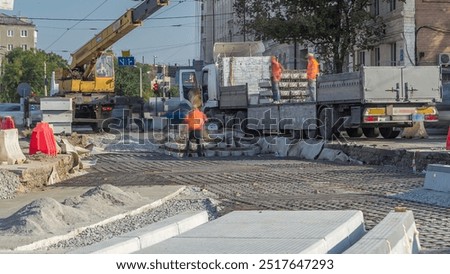 Loader crane for loading and unloading sleepers to reinforcement from oversized truck with an extended loading platform which stands on a road construction site aerial timelapse