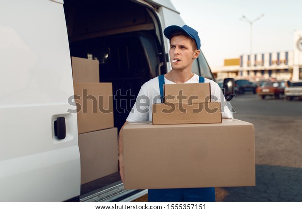 Loader holding\
stack of parcels, delivery\
service