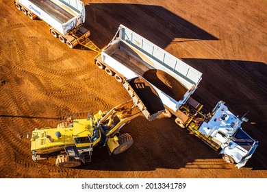 loader loading a semi trailer with iron ore - Shutterstock ID 2013341789