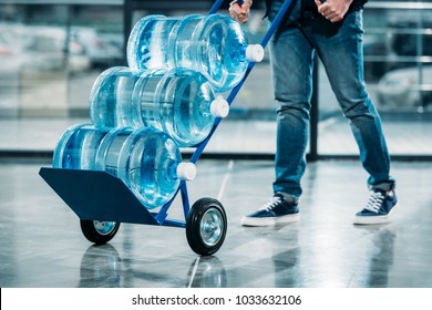 Loader pushing cart with water bottles