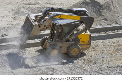 loader small bulldozer moving breakstone at construction area. view from above.