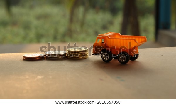 Loader truck and cement mixker yellow industrial\
car with money. Dump car is for carry money as business concept.\
Industrial lorry toy\
idea.