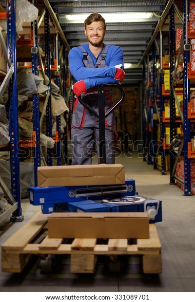 Loader using hand\
pallet truck in a warehouse\
