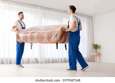 Loaders Carrying Furniture In Flat