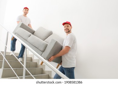 Loaders Carrying Furniture In The Stairway