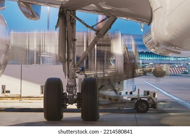 Loading Of Airplane At Airport. Cargo Container In Blurred Motion.
