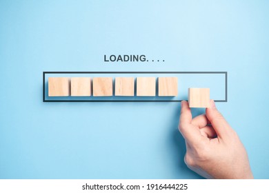 Loading bar with wooden blocks isolated on blue background.