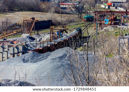 Loading breakstone into freight train in a granite quarry