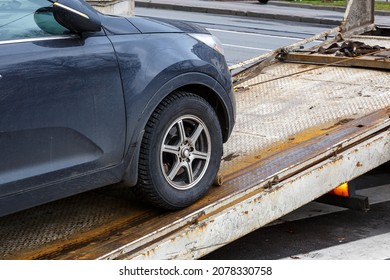 Loading a car onto a tow truck. Evacuation of a passenger car. Transportation of a faulty car to the place of repair. Selective focus.