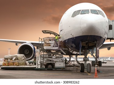 Loading Cargo On The Plane In Airport, View Through Window