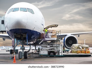 Loading Cargo On Plane In Airport Before Flight