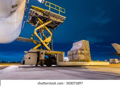 Loading Cargo On The Plane At Airport, Twilight Time
