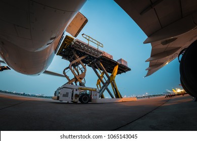 Loading Cargo Outside Cargo Plane With Twilight Sky