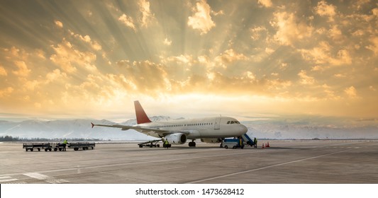 Loading Cargo Plane At Evening Sunset