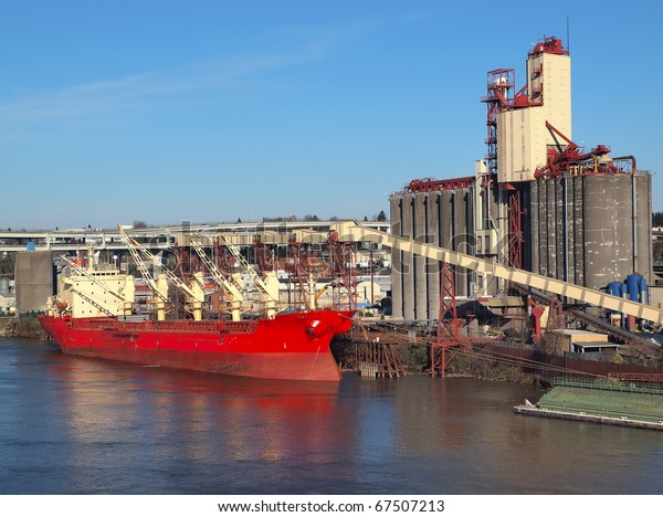 Loading a\
cargo ship, grain elevators Portland\
OR.