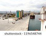 Loading cargoes of the cement clinker by ships cranes in the port of Izmir, Turkey.