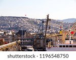 Loading cargoes of the cement clinker by ships cranes in the port of Izmir, Turkey.