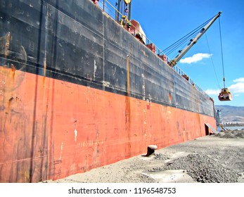 Loading Cargoes Of The Cement Clinker By Ships Cranes In The Port Of Izmir, Turkey.