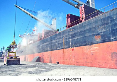 Loading Cargoes Of The Cement Clinker By Ships Cranes In The Port Of Izmir, Turkey.