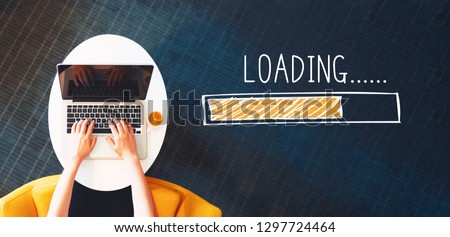 Loading concept with person using a laptop on a white table